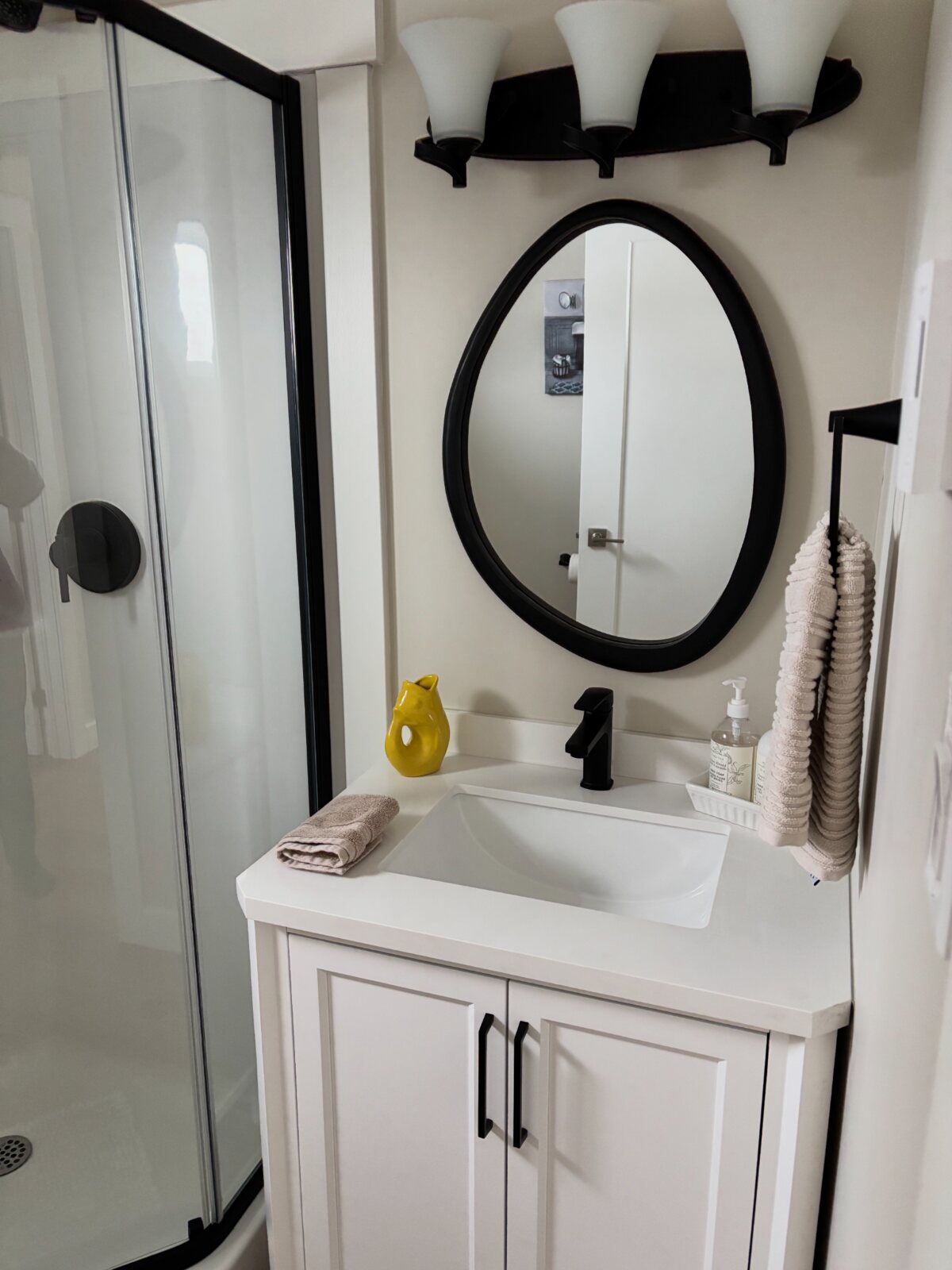 Modern bathroom vanity and walk-in shower at The Carriage House